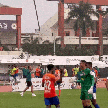 soccer players on a field with one wearing the number 42 jersey
