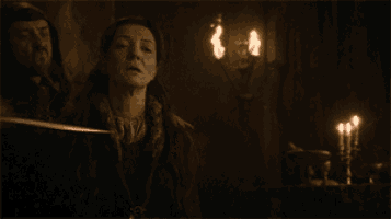 a woman is being held by a man in a dark room