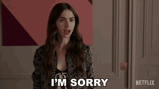 a woman says i 'm sorry in front of a netflix sign