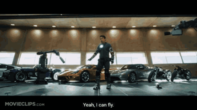 a movie clip from movieclips.com shows a man standing in front of a garage full of cars