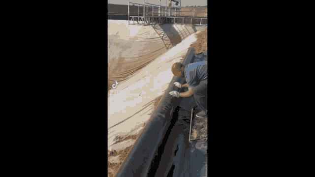a tiktok video of a person spray painting graffiti on a wall