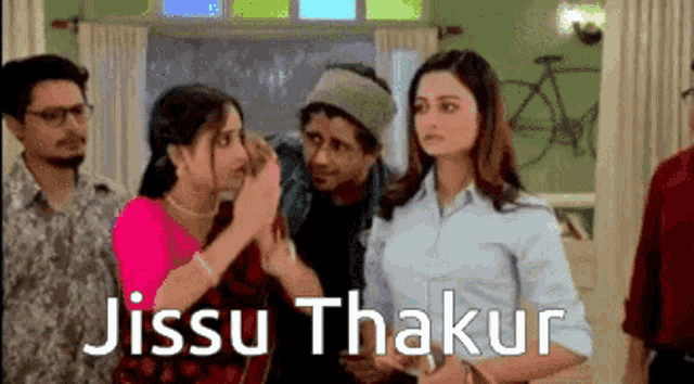 a group of people standing in a room with the words jissu thakur written on the bottom .