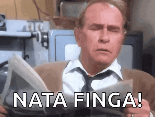 a man is reading a newspaper with the words nata finga written on it .