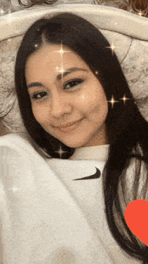 a woman is wearing a white nike sweatshirt