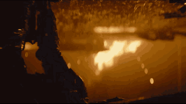 a dark room with a fire coming out of the ceiling
