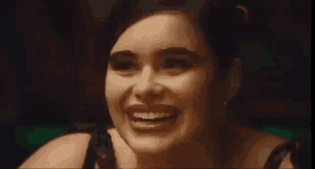 a close up of a woman 's face smiling .