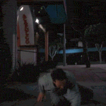 a person crawling on the ground in front of a sign that says eric