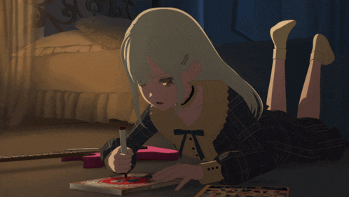 a girl is laying on the floor writing in a book