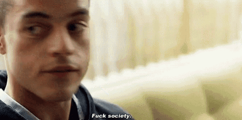 a close up of a man 's face with the words `` fuck society '' written on his face .