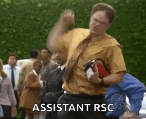 a man in a yellow shirt and tie is holding a fire extinguisher and dancing in front of a crowd .