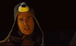 a man wearing a helmet and goggles is screaming with his mouth open