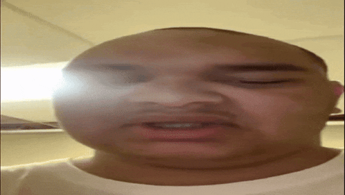 a close up of a man 's face with his eyes closed .