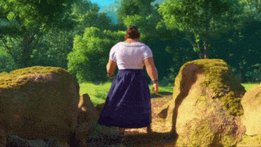 a woman in a blue skirt is walking through a field