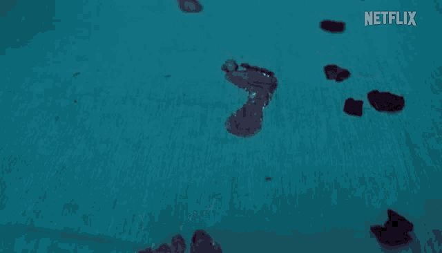 footprints on a blue surface with a netflix logo in the background