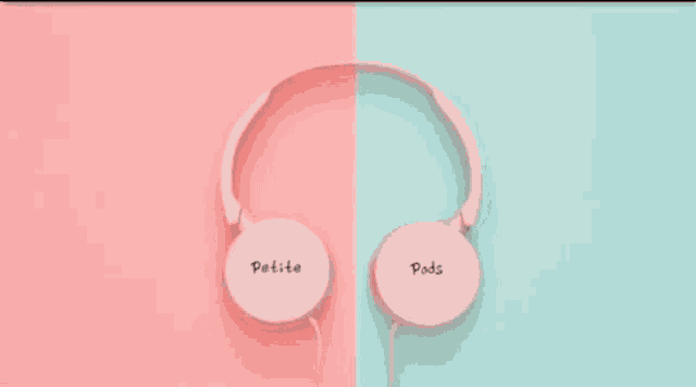 a pair of pink petite pods headphones are sitting on a pink and blue surface .