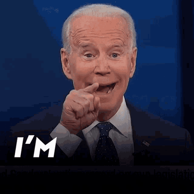 a man in a suit and tie says " i 'm coming " while pointing