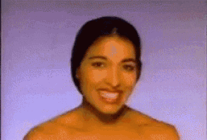 a close up of a woman 's face with a purple background