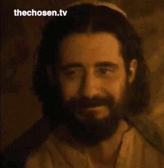 a close up of a man with a beard and the words " thechosen.tv " above him