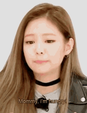 a woman is wearing a choker and a leather jacket and says `` mommy , i 'm hungry ! ''