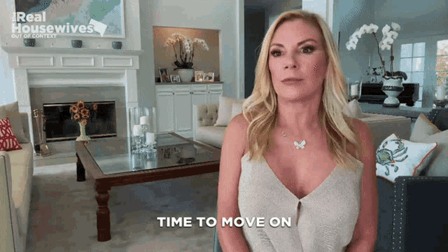 a woman in a living room with the words time to move on above her