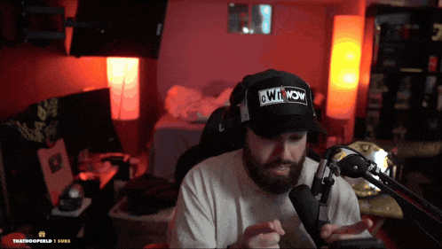 a man wearing a hat that says " owt now " on it