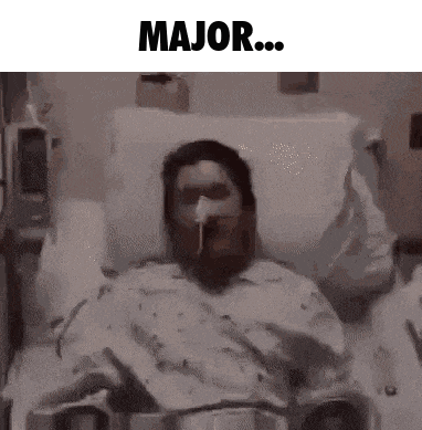 a man is laying in a hospital bed with an oxygen mask on his face and the words major written above him