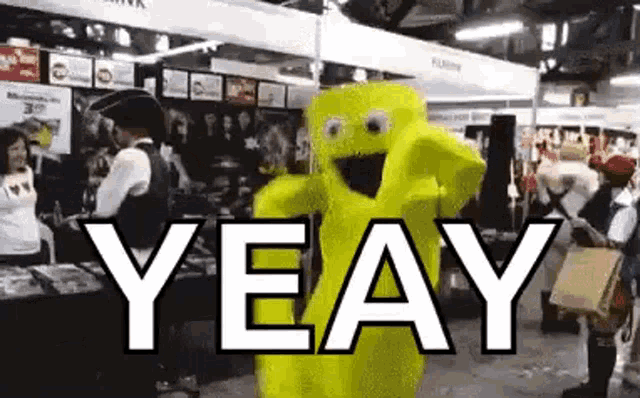 a yellow mascot is dancing in a room with the word yeay written on it .