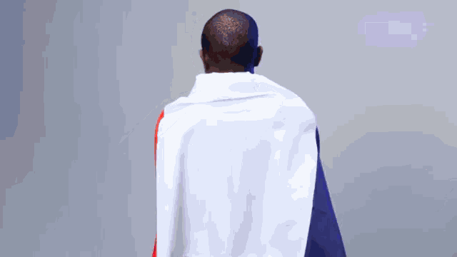 a man wrapped in a white red and blue blanket