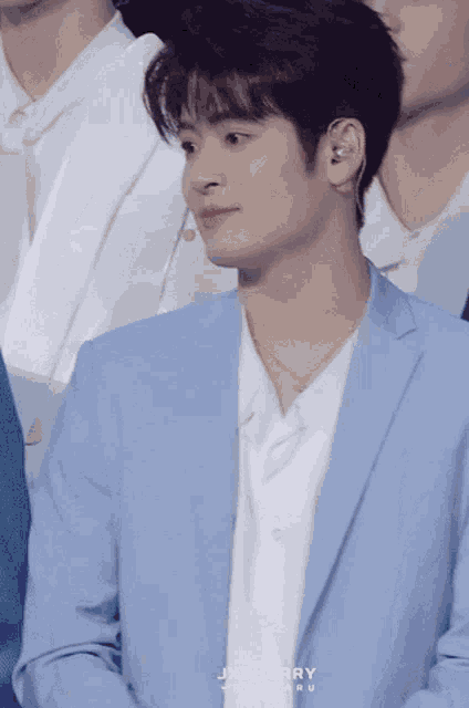 a man in a light blue suit has the name jxsherry on the bottom