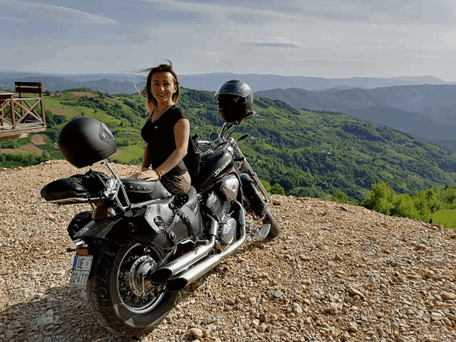 a woman is sitting on a motorcycle with a license plate that says jc - a1tf