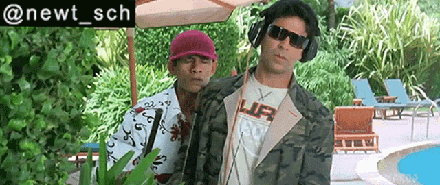 two men wearing headphones and sunglasses are standing next to a swimming pool ..