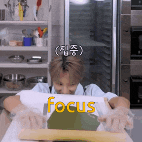 a man is rolling out dough and the word focus is on the table