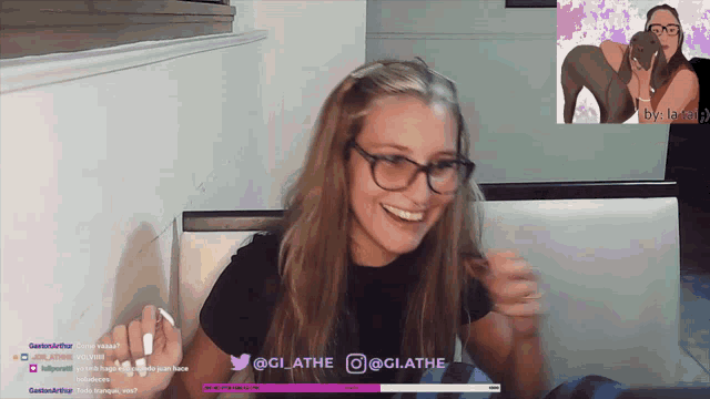 a woman wearing glasses is smiling in front of a screen that says ' @glathe ' on it