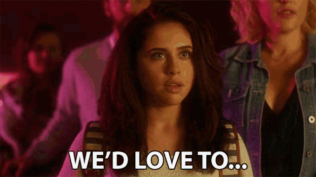 a woman is saying we 'd love to in a crowd of people .