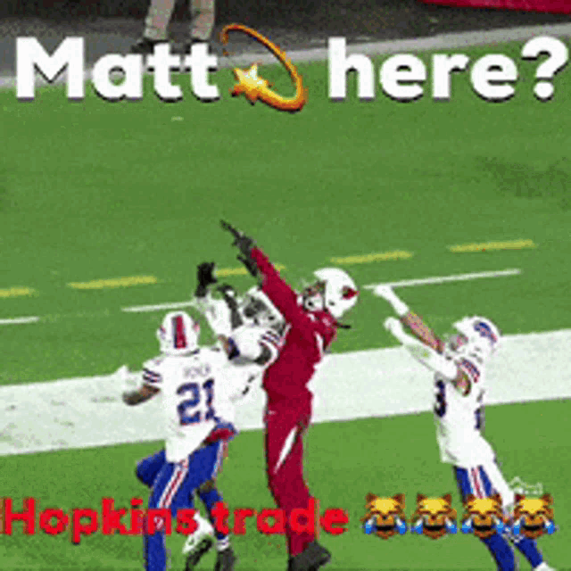 a football player with the number 21 on his jersey is trying to catch a pass