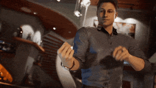 a man in a grey shirt is holding a piece of paper in his hands