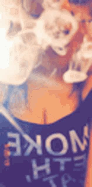 a woman is smoking a hookah and wearing a black shirt that says smoke .