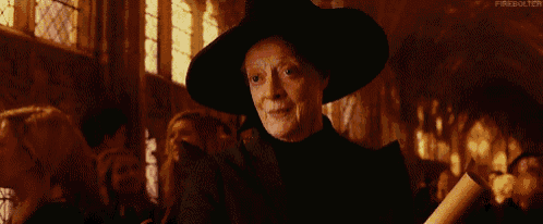 a woman in a black hat is holding a piece of paper in her hand