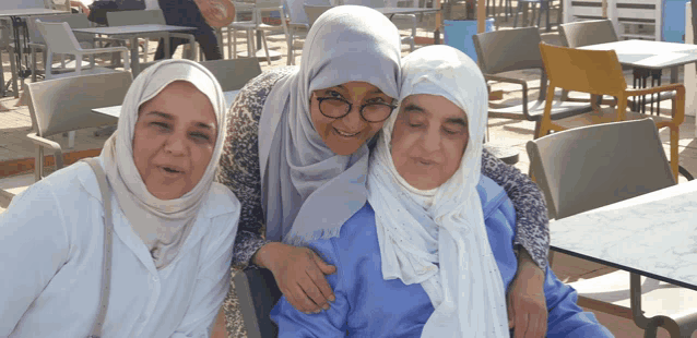 three women posing for a picture in a restaurant
