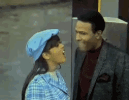 a man and a woman are kissing and the woman is wearing a blue beret