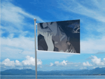 a flag with a picture of a man on it flies in the wind