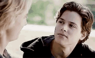a man and a woman are looking at each other and talking to each other .