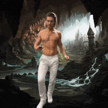 a man without a shirt is walking through a cave