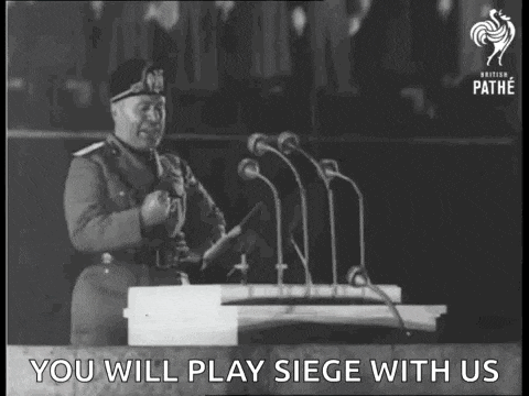 a man in a military uniform is giving a speech in front of a podium .