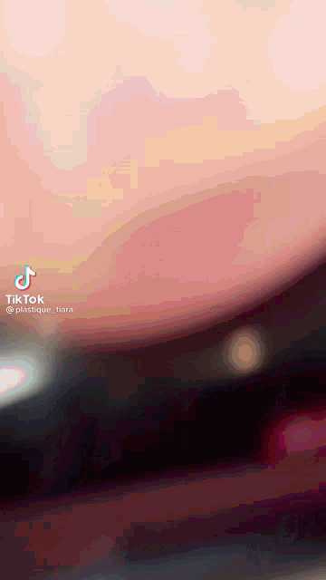 a blurred image of a person 's torso with a tiktok watermark