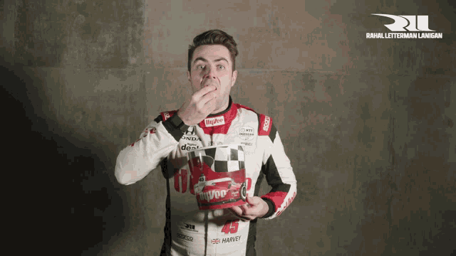 a man wearing a jacket that says ' jeep ' on it is eating something