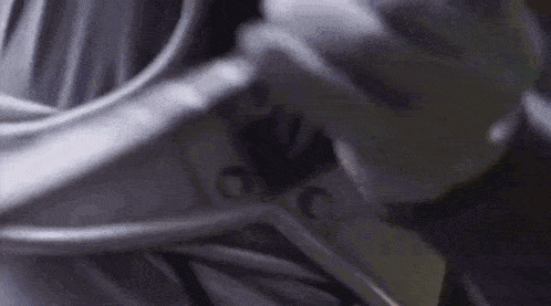a close up of a person 's hand holding a wheel with a blurred background .