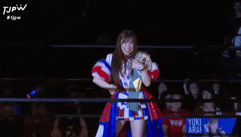 a woman in a boxing ring holds a belt that says ' jpw ' on it
