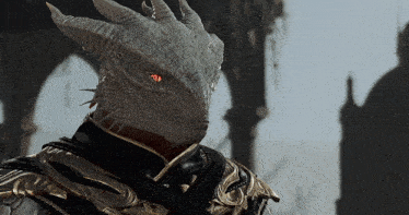 a close up of a dragon with red eyes and horns