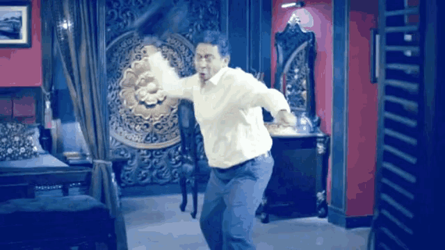 a man in a white shirt is dancing in a room
